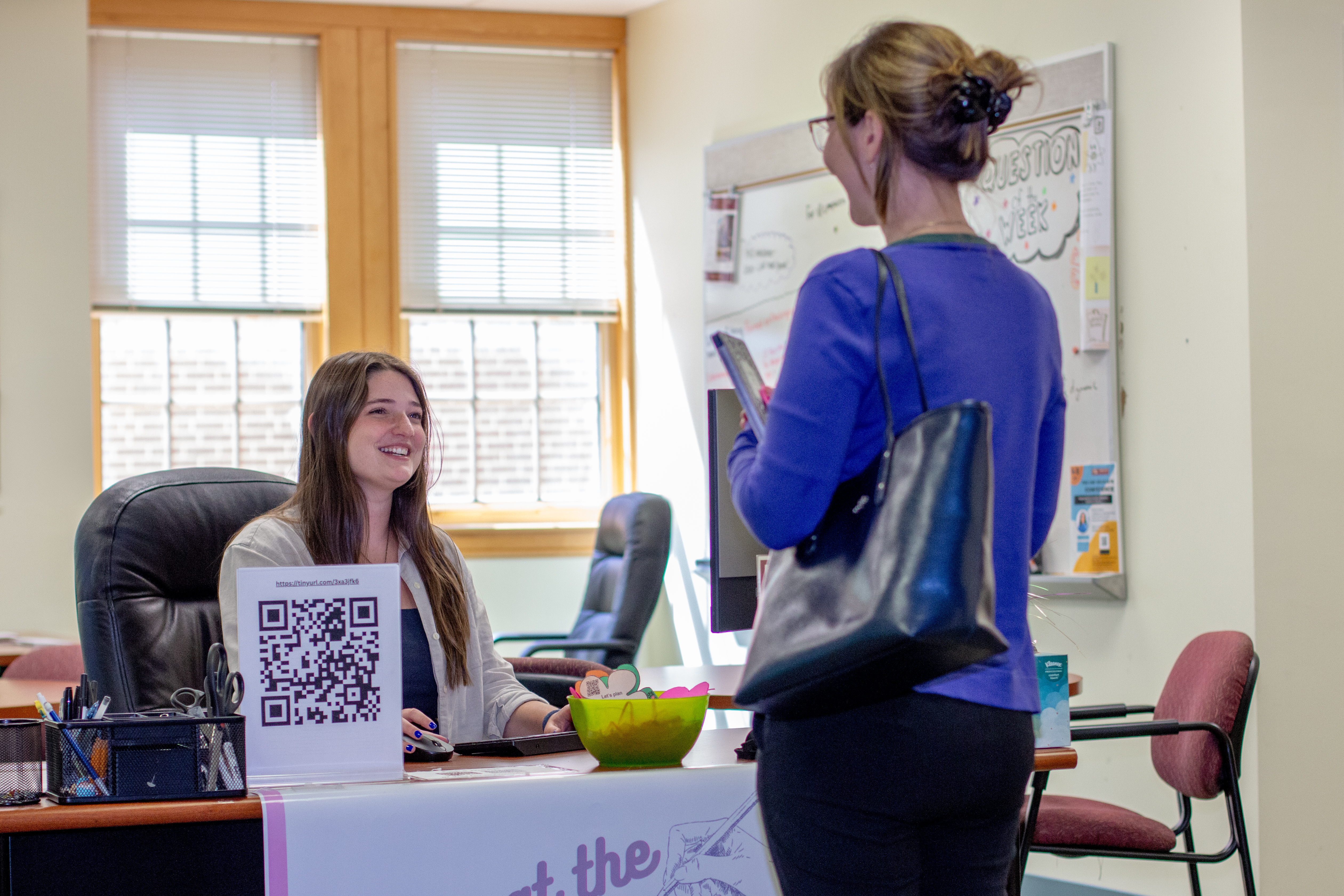 Writing center front desk with two students talking