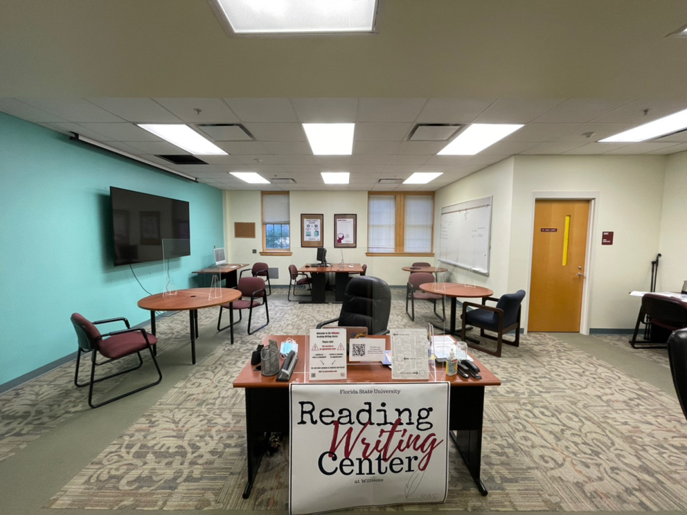 image of Williams Reading-Writing Center location with front desk and meeting tables